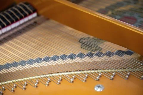 Closeup of a piano inside, parallel strings in a diagonal composition. Stock Photos