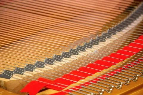 Closeup of a piano inside, parallel strings in a diagonal composition. Stock Photos