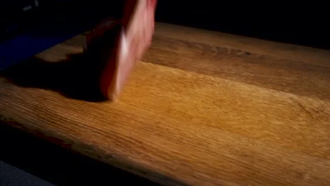 Closeup. Pieces of raw meat fall on a cutting board. Slow motion. Stock Footage 130786747