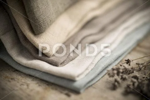Closeup of a Pile of Folded Dull-Colored Fabric Stock Photos