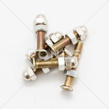 Closeup of a pile of screws screwed to their nuts isolated on white background Stock Photos