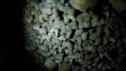 Closeup of piles of skulls and bones in Catacombs Stock Footage 98034914