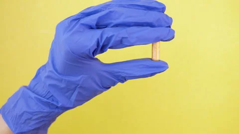 Closeup pill capsule held in gloved hand. medical worker doctor in lab. isolated Stock Footage 130817242
