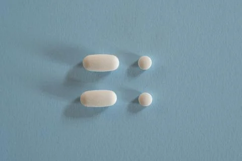 Closeup of with pills on blue background Stock Photos