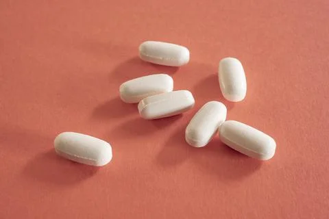 Closeup of with pills on red background Stock Photos