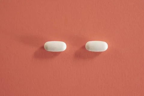 Closeup of with pills on red background Stock Photos