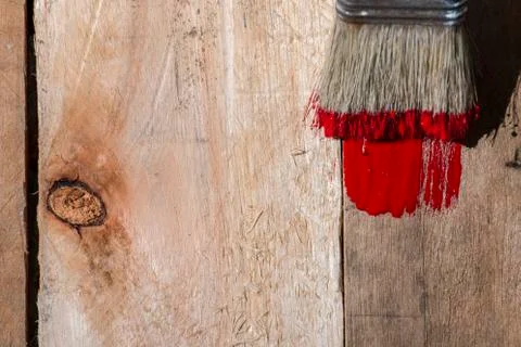 Closeup Of Pine Plank Being Painted In Red Color Stock Photos