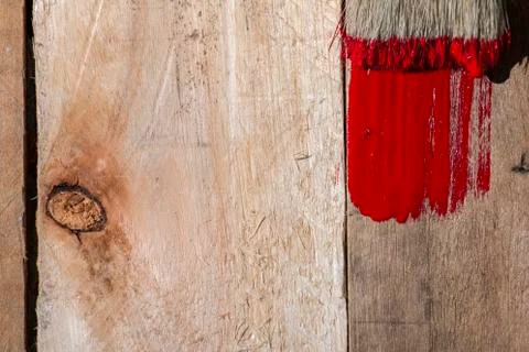 Closeup Of Pine Plank Being Painted In Red Color Stock Photos