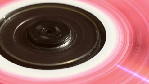 Closeup of pink CD spinning inside retro player, glowing with nostalgic 90s Stock Footage 305573688