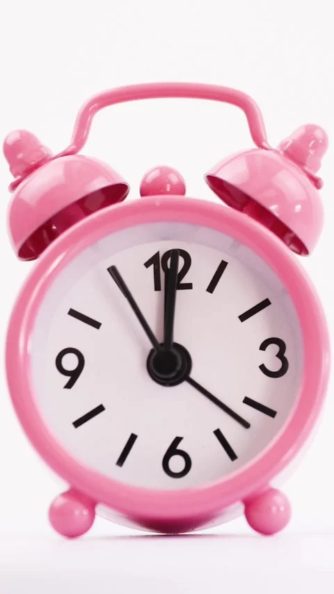 Closeup of a pink clock on a white background for mobile Stock Footage 242481055