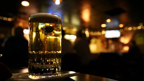 Closeup of Pint of Beer under Flickering Bar Lights Stock Footage 122047071