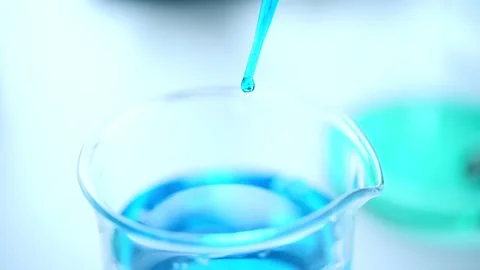 Closeup-pipette dropping a sample into a test tube in an experiment resea Stock Footage 131581626