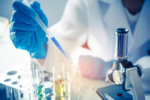 Closeup-pipette dropping a sample into a test tube in an experiment research  Stock Photos