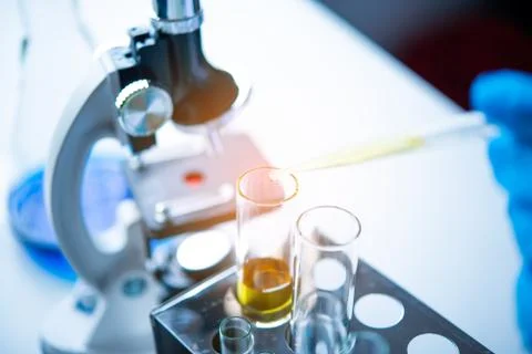 Closeup-pipette dropping a sample into a test tube in an experiment research  Stock Photos