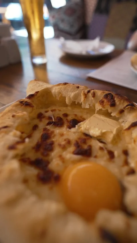 Closeup pizza with egg, butter, missing slice, focusing on food details Stock Footage 279818931