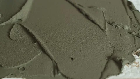 Closeup of plaster applied with tile adhesive with a trowel. Male hands apply Stock Footage 154697678