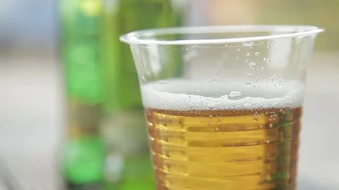 Closeup of a plastic Cup of beer standing on the table in a cafe Video stock 71904718