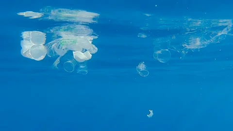 Closeup of plastic pollution of the Ocean. A lot of plastic debris drifting Stock Footage 144029138
