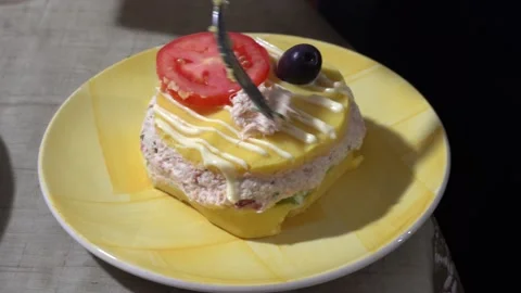 Closeup of a plate of causa with crab pulp in 4k with tomato, mayonnaise and Stock Footage 156446789