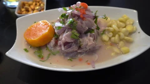 Closeup of a plate of ceviche with corn, sweet potato and canchita cerrana on a Video stock 163680489