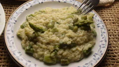 Closeup on plate of risotto with green asparagus Stock Footage 131862255