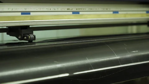 Closeup plotter operates with black polyethylene piece Stockbeeldmateriaal 101287750