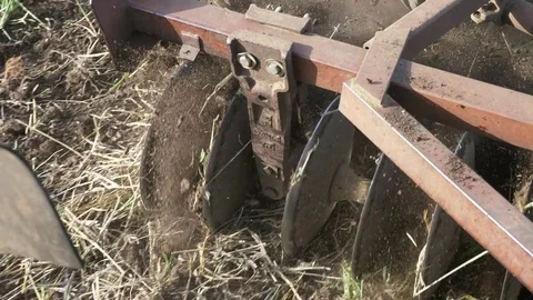 Closeup of plow attached to a tractor plowing a field. Stock Footage 78367370