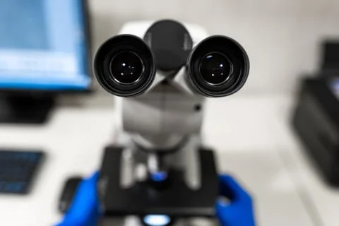 Closeup point of view of laboratory assistant looking through microscope lens Stock Photos