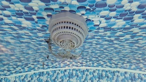 Closeup of pool filter operation underwater with blue mosaic tiles in motion Stock Footage 316707466