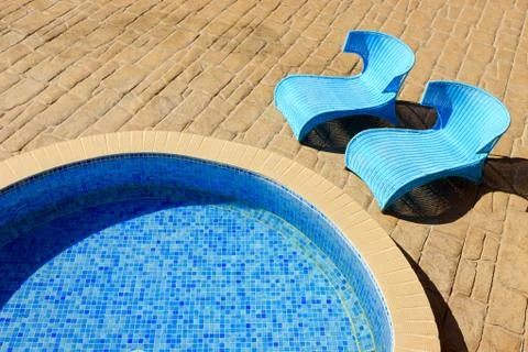 Closeup of a pool with sunbeds Stock Photos