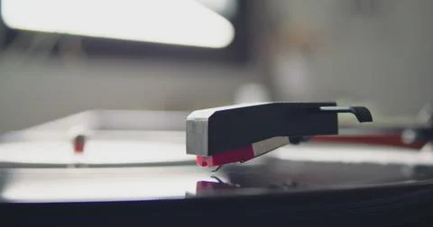 Closeup of portable vintage headshell of record player going down playing on Stock Photos