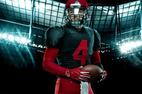 Closeup portrait of american football player, athlete sportsman in red helmet on Stock Photos