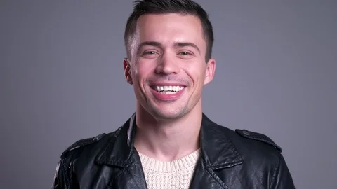 Closeup portrait of attractive caucasian man laughing while looking at camera Stock Footage 101034366
