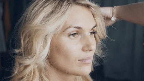 Closeup portrait of beautiful European young blonde woman. Finish hairstyle Stock Footage