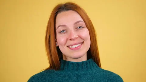 Closeup portrait of charming young red hair woman looking at camera with kind Stock Footage 148584981