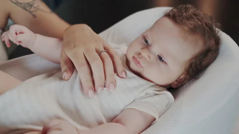 Closeup of Portrait of Cute Sweet Tiny Baby Lying in Nursery. Babysitter or Stock Footage 149805487