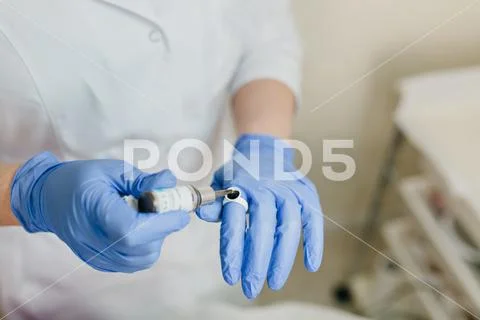 Closeup portrait of doctor s hands in blue gloves working with medicene Stock Photos