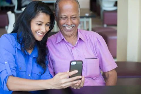 Closeup portrait elderly gentleman in pink shirt and lady in blue top family  Stock Photos