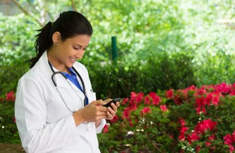 Closeup portrait, friendly, young smiling confident female doctor with stetho Stock Photos