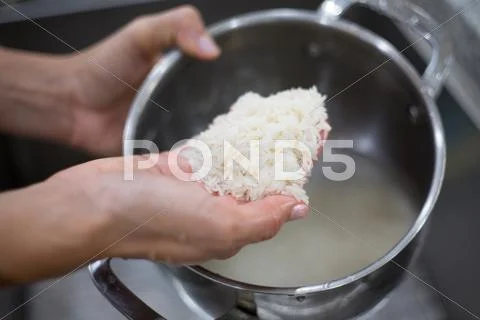 Closeup Portrait Of Hands Washing Jasmine Rice To Free From Dust And Dirt Bef