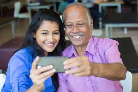 Closeup portrait happy elderly gentleman in pink shirt and lady in blue top t Foto stock