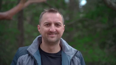 Closeup portrait of a man with a cleft lip looking at the camera smiling and Video stock 126774642
