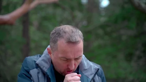 Closeup portrait of man with cleft lip coughs closing his mouth with his fist Stock Footage 126774724