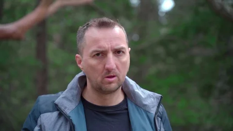 Closeup portrait of a man with a cleft lip nods negatively, disagreeing with Stock Footage 126774754