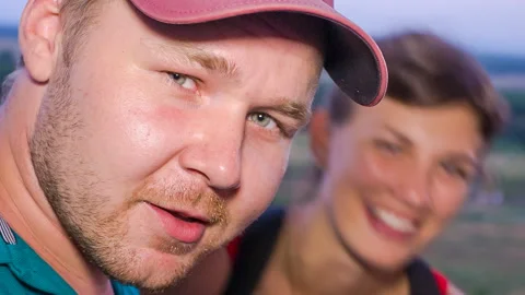 Closeup portrait of the man looking cautious, the girl laughing Stock Footage 113614767