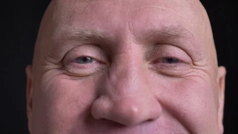Closeup portrait of middle-aged caucasian man with eyes looking straight at Stock Footage 103361953