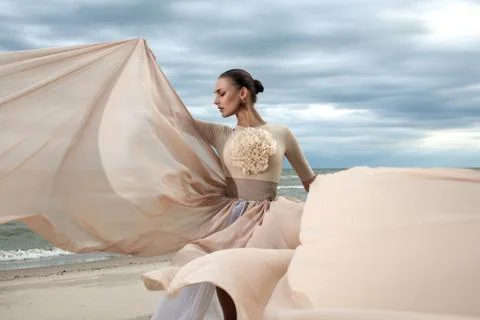 Closeup portrait of model face during posing with long dress at beach Stock Photos