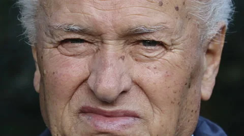 Closeup portrait of an old retired man using a vintage film camera  Stock Footage 68751122