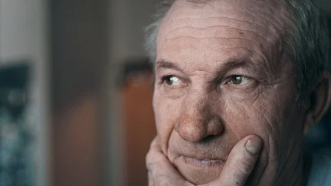 Closeup portrait of a pensive elderly man, looking to the side. Stock Footage