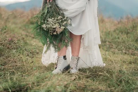 Closeup portrait of pretty bride in luxury wedding dress with bouquet Stock Photos